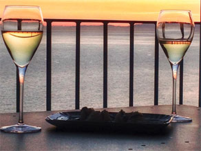 Two glasses of wine at sunset in Liguria